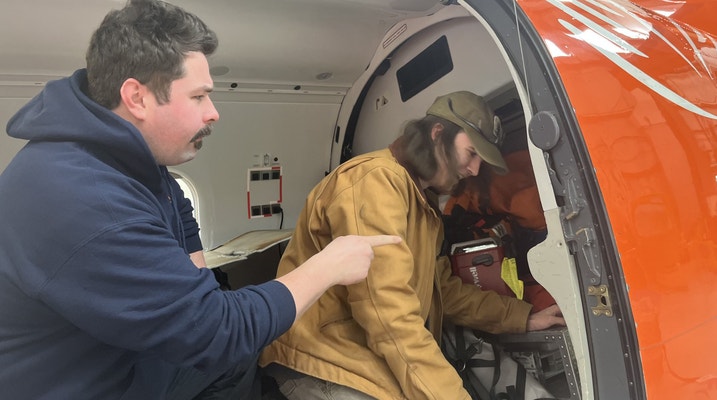 Two men inside ORNGE Aircraft
